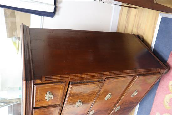 A George III walnut chest of drawers, on bun feet W.101cm